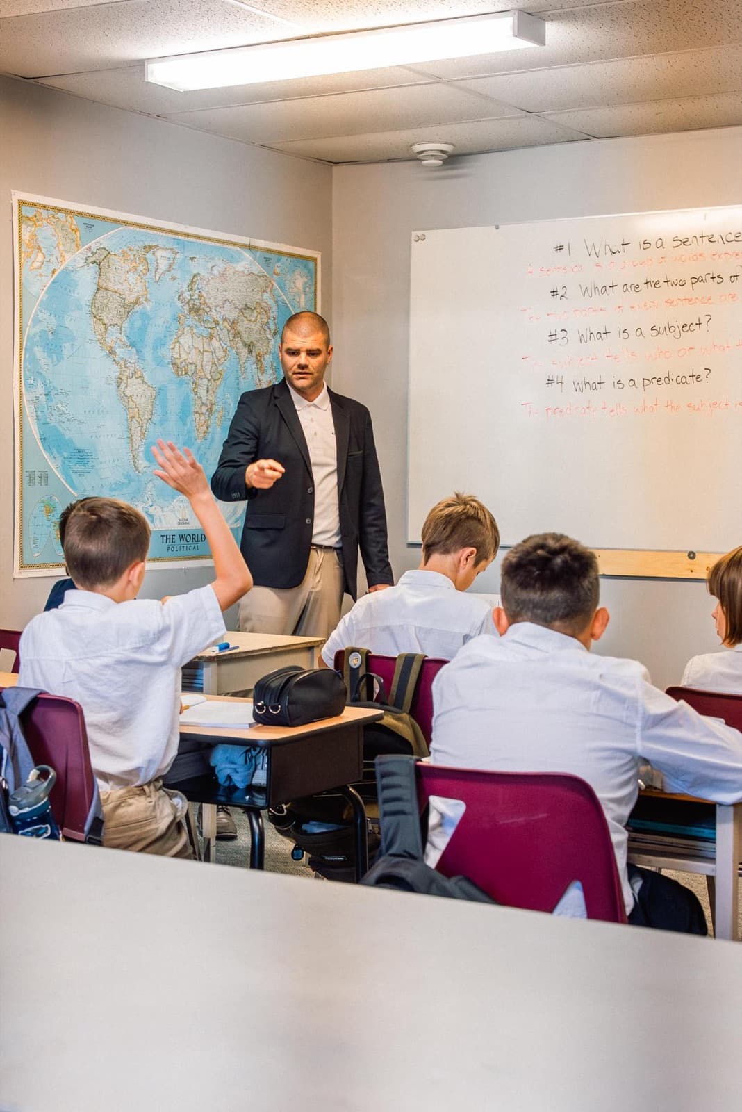 A grammar lesson at King's Cross Academy, with a student's hand raised